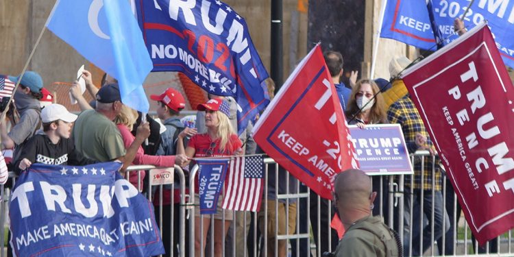 President Donald Turmp supporters gather outside Walter Reed National Military Medical Center in Bethesda, Md., Sunday, Oct. 4, 2020. Trump was admitted to the hospital after contracting COVID-19. (AP Photo/Anthony Peltier)