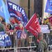 President Donald Turmp supporters gather outside Walter Reed National Military Medical Center in Bethesda, Md., Sunday, Oct. 4, 2020. Trump was admitted to the hospital after contracting COVID-19. (AP Photo/Anthony Peltier)